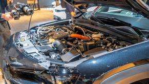 Under the hood of a Mazda MX-30 R-EV model showing its powertrain with a Wankel rotary engine range extender