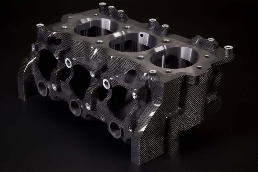 Bare Nissan carbon fiber engine block against black background