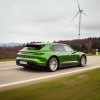 A 2023 Porsche Taycan Cross Turismo station wagon blasts across an open road.