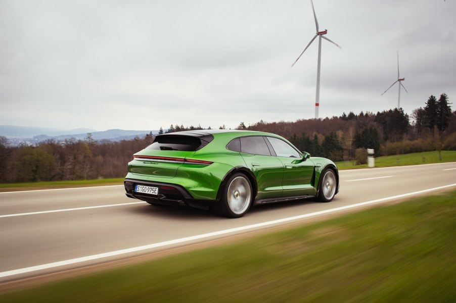 A 2023 Porsche Taycan Cross Turismo station wagon blasts across an open road.