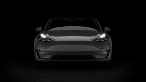 A black 2023 Tesla Model 3, one of the fastest cars in the world for the price, shows off its front-end.