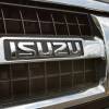 Close up image of the Isuzu logo on the grille of an SUV.