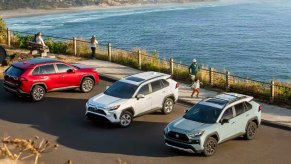 Three Toyota RAV4 small SUVs are parked.