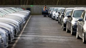 Rows of used cars parked at a dealership.