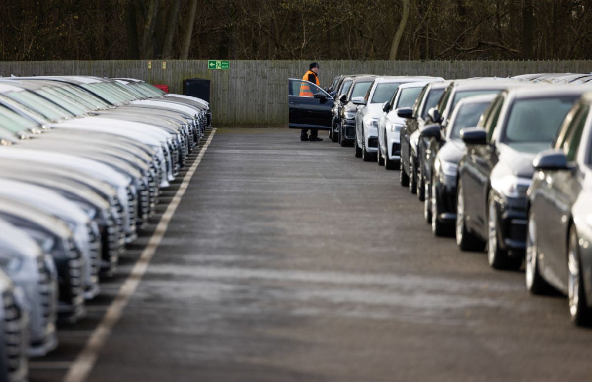 Rows of used cars parked at a dealership.