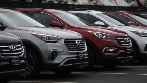 2011 Hyundai Santa Fe SUVs sitting on a dealership lot.