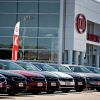 Used Kia cars lined up on display at a dealership.