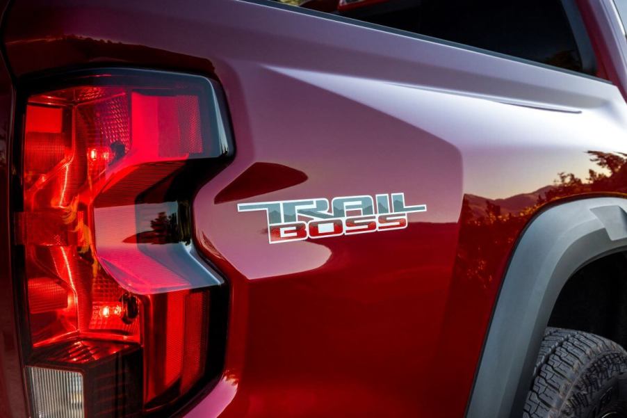 A red 2023 Chevy Colorado midsize pickup truck model with Trail Boss markings on the vehicle's bed