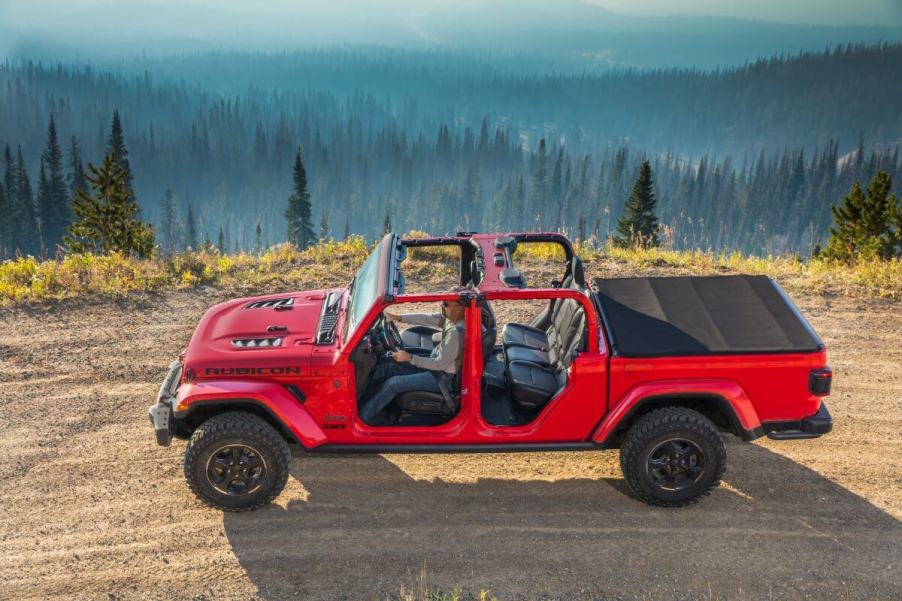 The removable convertible top roof on a 2023 Jeep Gladiator Rubicon midsize pickup truck model on a forest hill