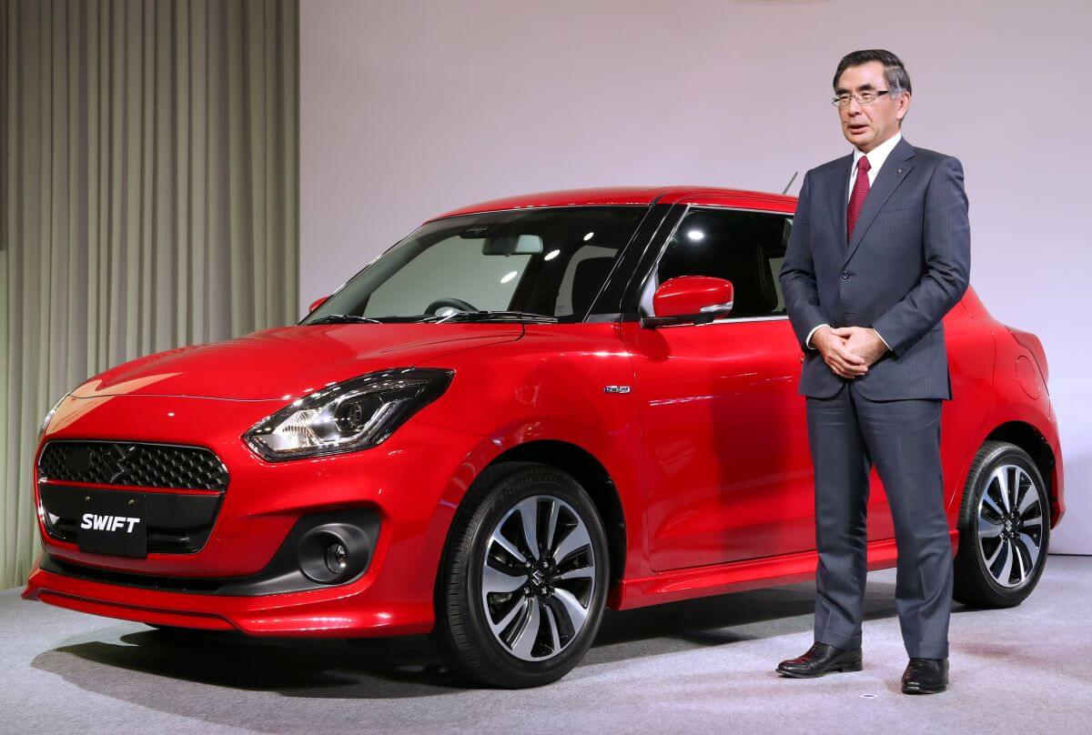 A new, red Suzuki Swift compact hatchback model introduced in Tokyo, Japan