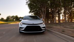 A front shot of the hood and grille of a 2023 Toyota Corolla XSE compact car model in Wind Chill Pearl