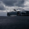 The 2023 Acura TLX Gotham Gray Edition parked with stormy clouds in the background