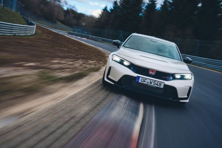 A white 2023 Honda Civic Type R speeding down an open track.