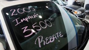 Pink market on a windshield of a white 2005 Chevy Impala full-size sedan at Hoskin Chevrolet in Elk Grove, Illinois