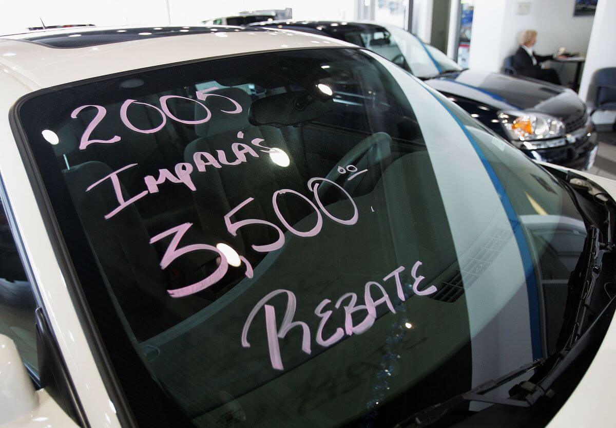 Pink market on a windshield of a white 2005 Chevy Impala full-size sedan at Hoskin Chevrolet in Elk Grove, Illinois