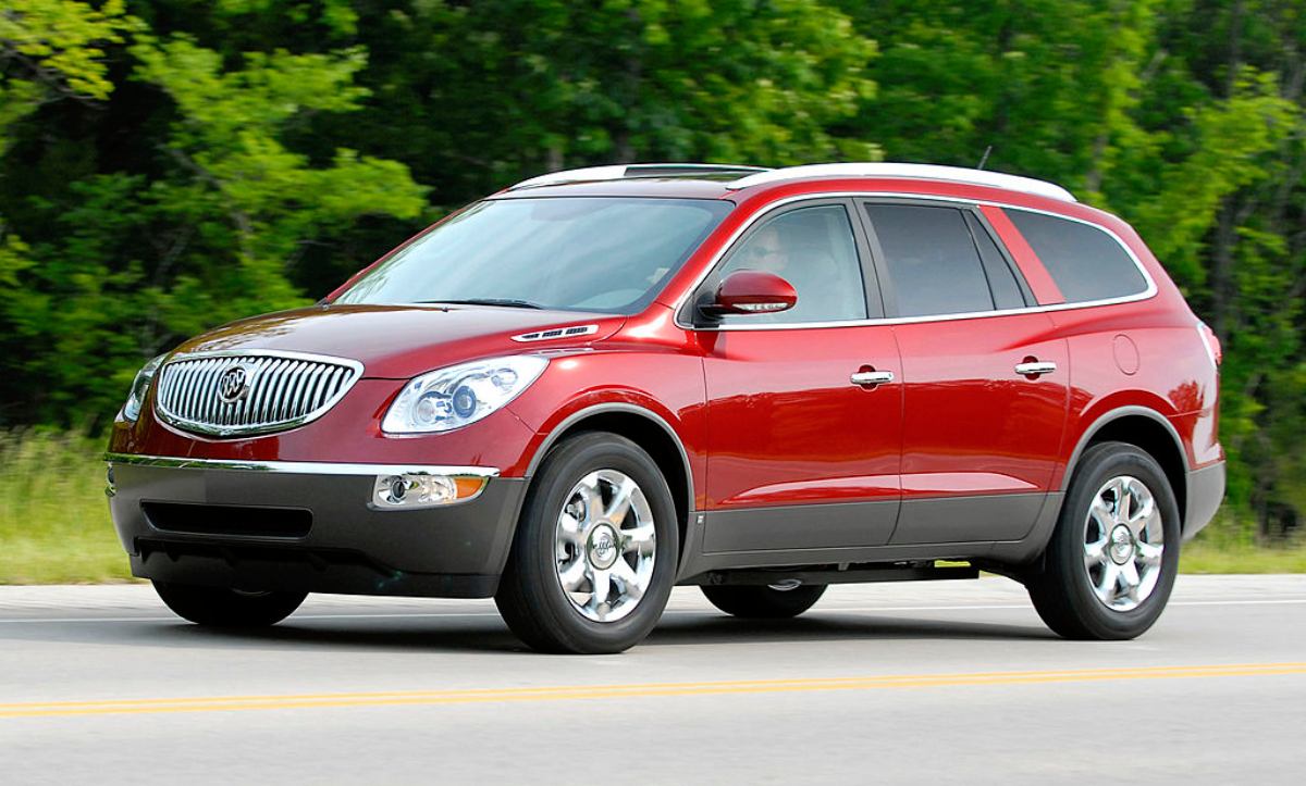 A red 2008 Buick Enclave driving on a highway.