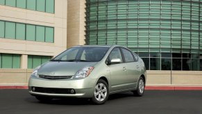 A used 2008 Toyota Prius parks next to a business complex.