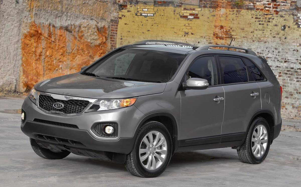 A 2011 Kia Sorento, one of the worst Sorento model years, parked next to a brick wall