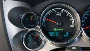 Closeup of the hybrid icon in the tachometer of a 2012 GMC Sierra full-size pickup truck with the two-mode CVT transmission.