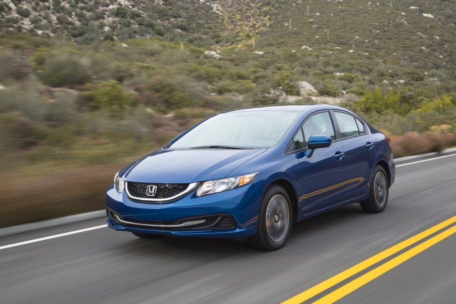 A front view of the 2014 Honda Civic driving down a road.