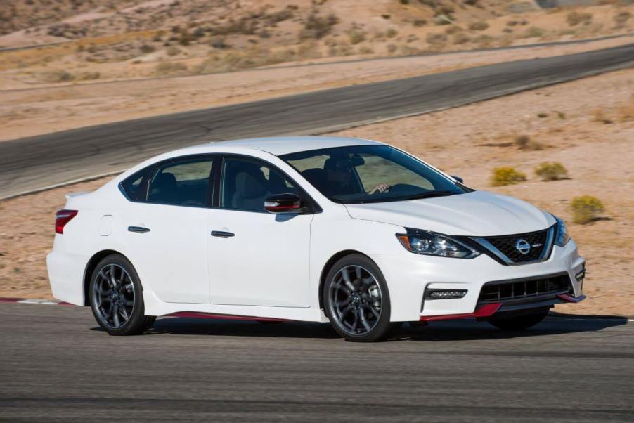 A white 2018 Nissan Sentra NISMO compact sedan model with a performance style package on a desert road