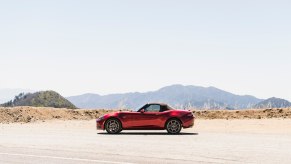 A red 2023 Mazda MX-5 Miata parked in the desert