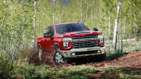 Red 2022 Chevy Silverado 2500 HD parked in the forest