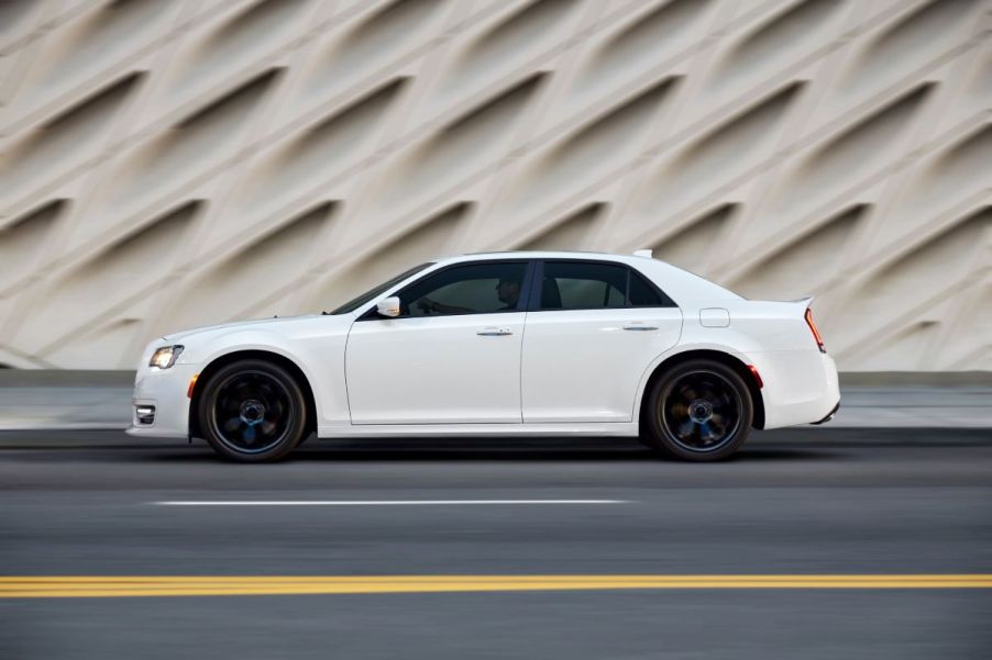 A white 2022 Chrysler 300 parked on a street downtown