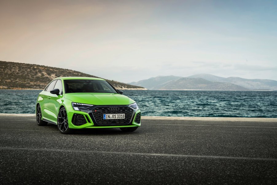 A lime green 2023 Audi A3 Sedan parked by the water