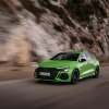 A lime green 2023 Audi A3 Sedan driving down the road