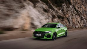 A lime green 2023 Audi A3 Sedan driving down the road