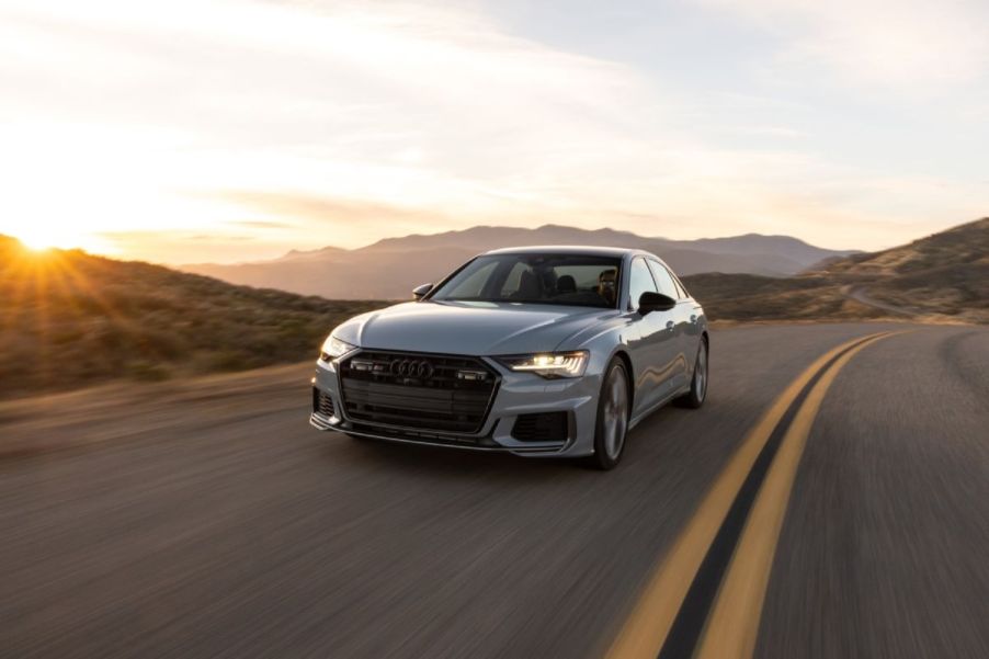 A gray 2023 Audi S6 driving down an open road.