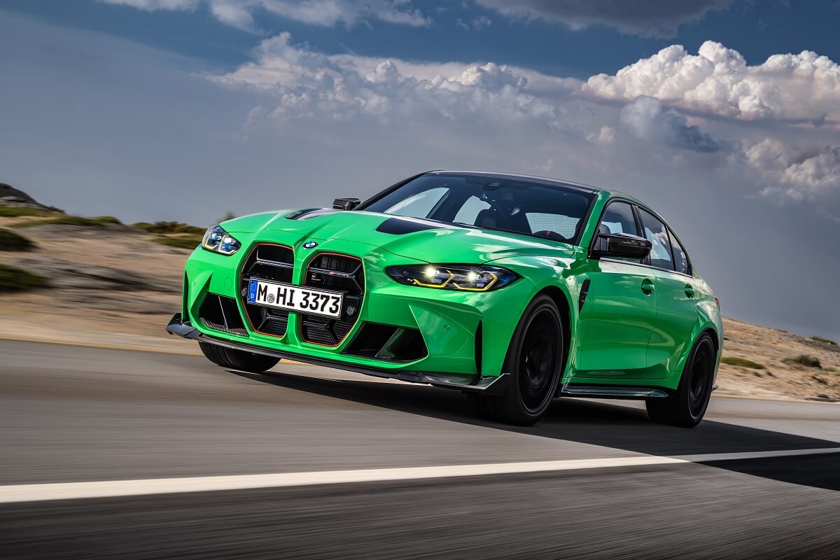 A green BMW M3 four-door, which compares to the BMW M4 coupe