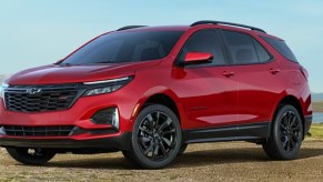 A red 2023 Chevrolet Equinox small SUV is parked off-road.