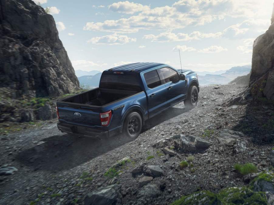 The 2023 Ford F-150 with one cab configuration climbing up a mountain