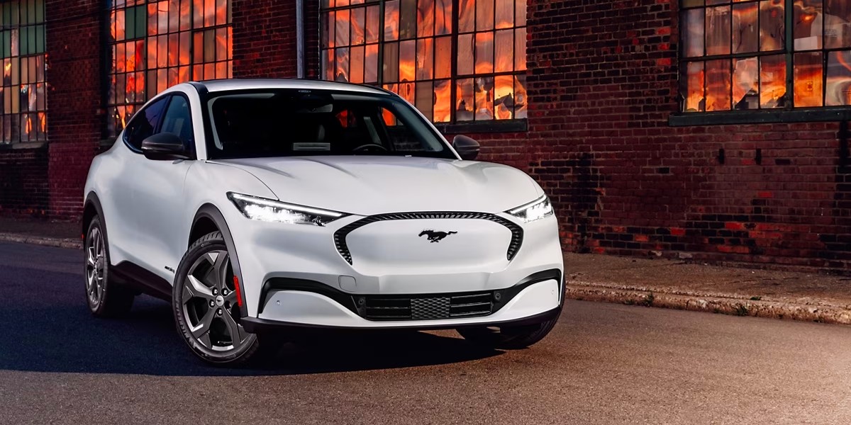 A white 2023 Ford Mustang Mach-E small electric SUV is parked.