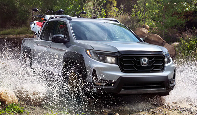 The 2023 Honda Ridgeline driving through water