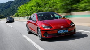 Red 2023 Hyundai Ioniq 6 Electric Sedan Driving on a Road