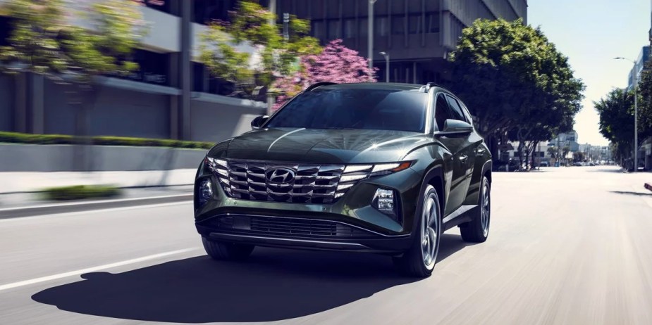 A gray 2023 Hyundai Tucson Plug-In Hybrid is driving. 