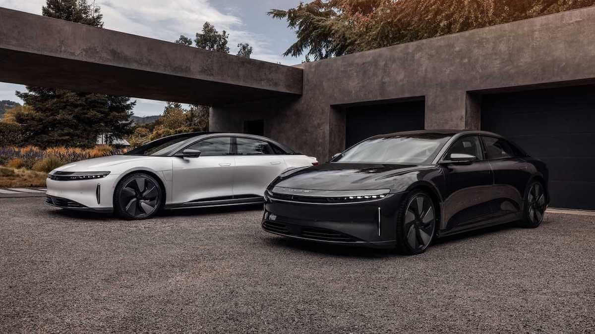 Two 2023 Lucid Air EV sedans in front of building