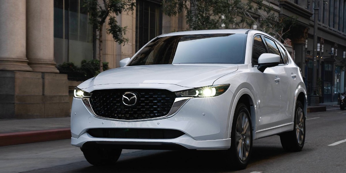 The best-selling Mazda model, the 2023 CX-5, drives on a city street.