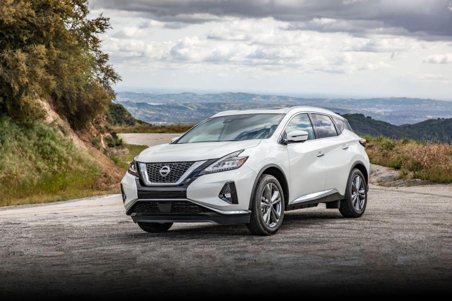 White 2023 Nissan Murano parked on a cliff at high altitude.