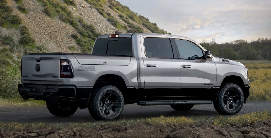 View of the bed of a Ram 1500 eTorque hybrid pickup truck parked on a country road.