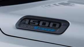 Closeup of a hybrid half-ton Ram truck's black "1500 Hemi eTorque" hood badge.