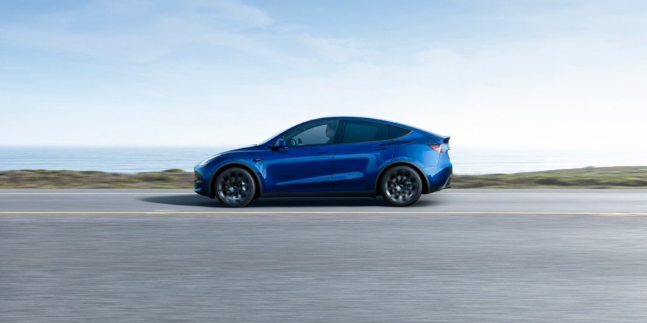 A black 2023 Tesla Model Y small electric SUV is parked. 