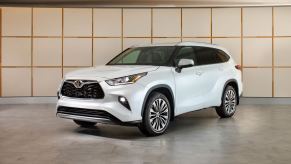 A 2023 Toyota Highlander on display in a showroom.