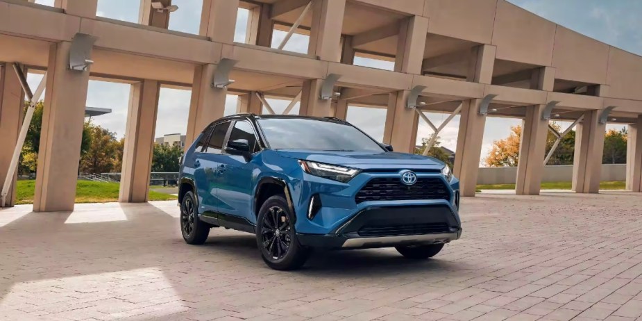 A blue 2023 Toyota RAV4 Hybrid small hybrid SUV is parked. 