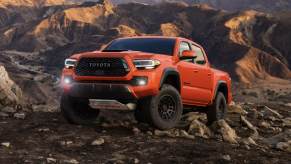 The 2023 Toyota Tacoma off-roading over rocky terrain.