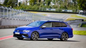 A blue 2023 Volkswagen Golf R Estate parked on a track