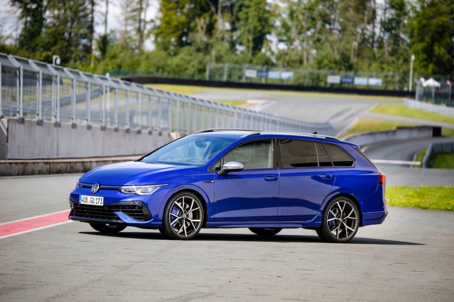 A blue 2023 Volkswagen Golf R Estate parked on a track